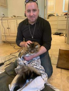 Roy Coffey Swaddles a long haired tabby cat