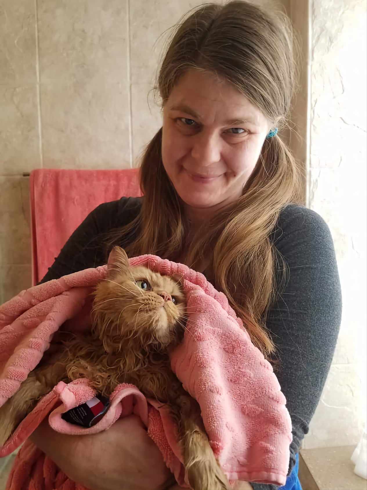 Carolyn Black-Coffey and a wet red cat after his bath